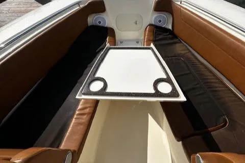 Slide: The Image of 2015 Scout 275 Dorado boat interior with brown seating and a central table. - 18