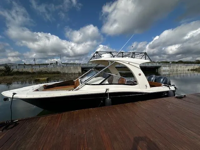 Slide: The Image of 2015 Scout 275 Dorado boat docked under cloudy sky. - 2