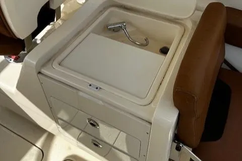 Slide: The Image of 2015 Scout 275 Dorado boat interior with sink and storage drawers. - 22