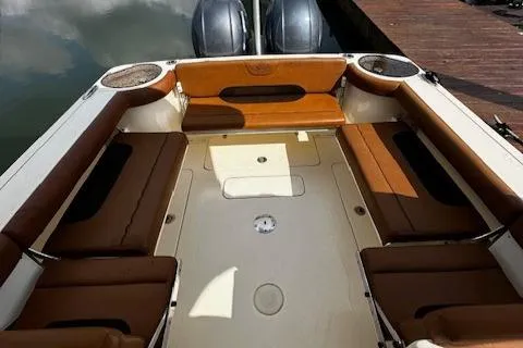 Slide: The Image of 2015 Scout 275 Dorado boat interior with brown seating and twin engines. - 23