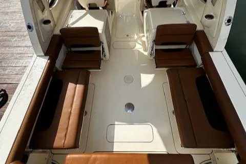 Slide: The Image of 2015 Scout 275 Dorado boat interior with brown seating and spacious layout. - 24