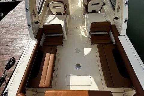 Slide: The Image of 2015 Scout 275 Dorado boat interior with brown seating and spacious layout. - 25