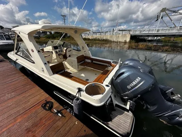 Slide: The Image of 2015 Scout 275 Dorado boat docked with Yamaha engines, under a partly cloudy sky. - 26