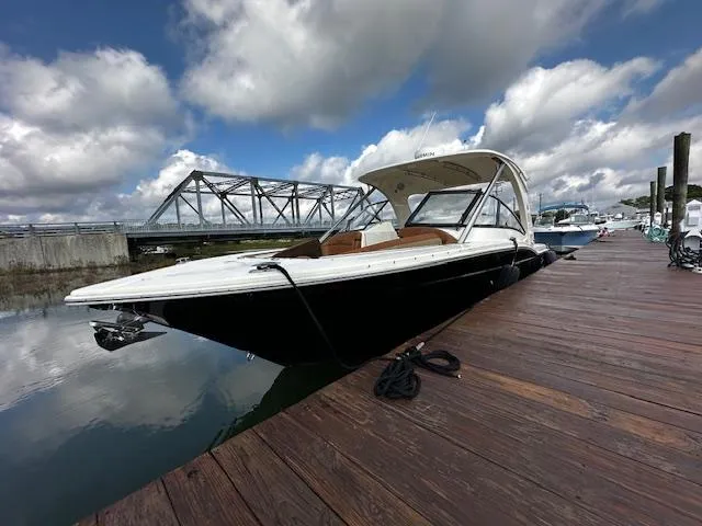 Slide: The Image of 2015 Scout 275 Dorado boat docked under cloudy sky. - 3