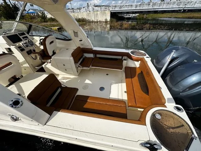 Slide: The Image of 2015 Scout 275 Dorado boat interior with brown seating and dual engines. - 7