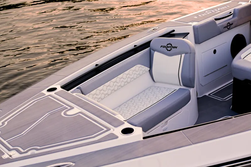 Slide: The Image of 2025 Fountain 38 SCX boat interior with sleek seating and modern design on calm water. - 15