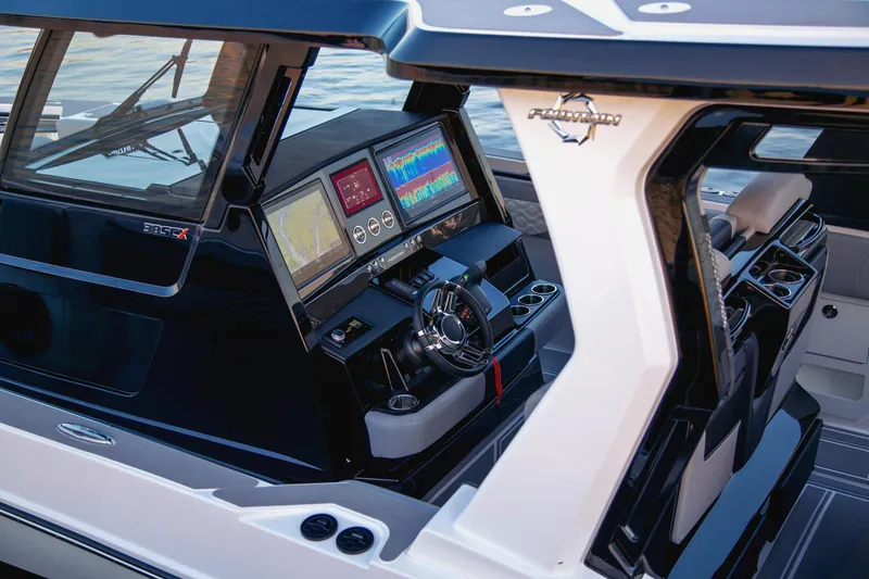 Slide: The Image of 2025 Fountain 38 SCX boat cockpit with advanced navigation displays and steering wheel. - 16