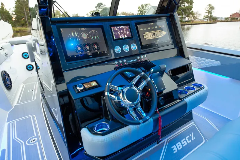Slide: The Image of 2025 Fountain 38 SCX boat dashboard with advanced navigation controls and digital displays. - 17