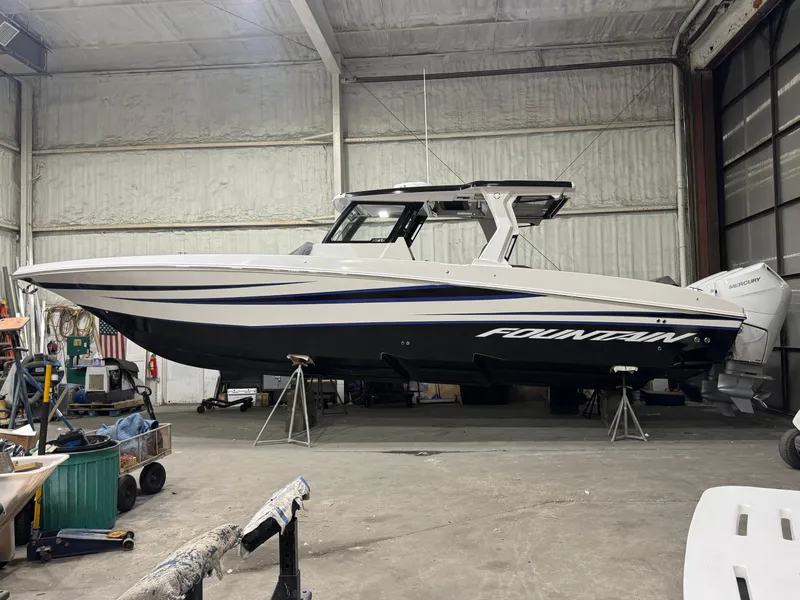 Slide: The Image of 2025 Fountain 38 SCX boat in a warehouse, side view. - 27