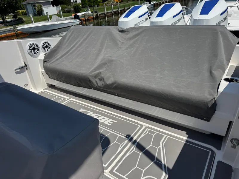 Slide: The Image of 2025 Fountain 38 SCX boat deck with covered seating and Mercury engines. - 28