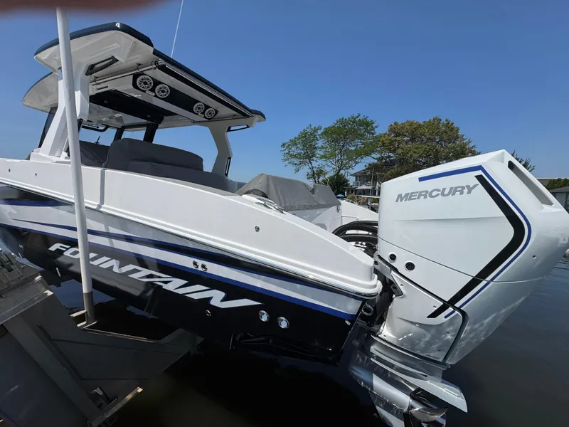 Slide: The Image of 2025 Fountain 38 SCX boat with Mercury engine, docked on a sunny day. - 3