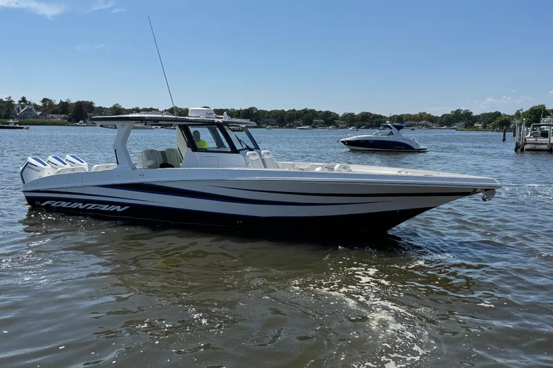 Slide: The Image of 2025 Fountain 38 SCX boat on calm water, featuring sleek design and powerful engines. - 33