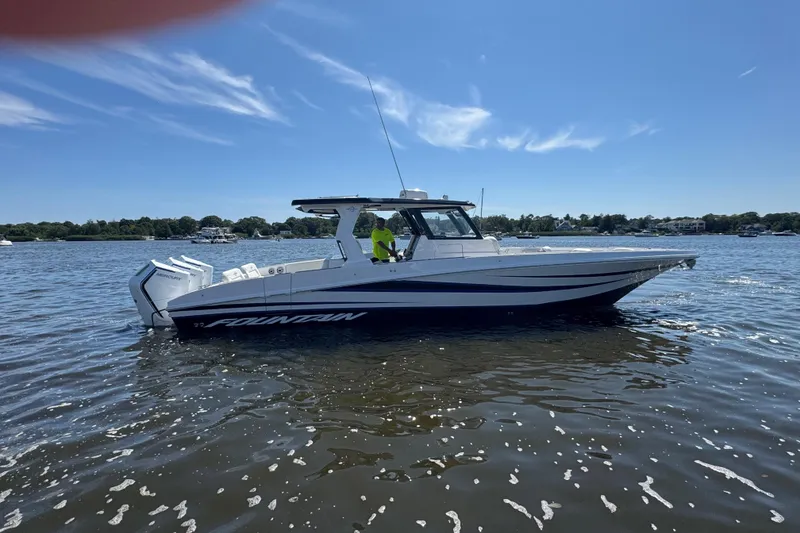 Slide: The Image of 2025 Fountain 38 SCX boat on calm water under clear blue sky. - 37
