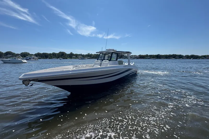 Slide: The Image of 2025 Fountain 38 SCX boat cruising on a sunny day in calm waters. - 41