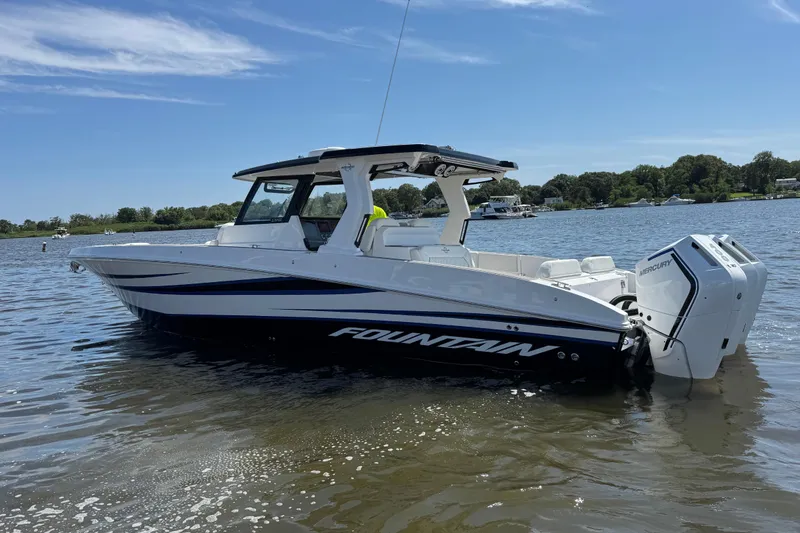 Slide: The Image of 2025 Fountain 38 SCX boat on calm water, featuring sleek design and powerful engines. - 42