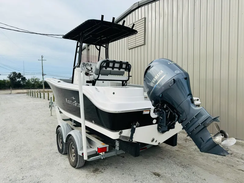 Slide: The Image of 2022 NauticStar 2102 Legacy boat with Yamaha outboard motor on trailer. - 13