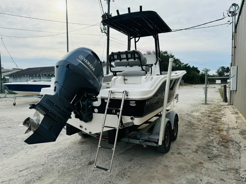 Slide: The Image of 2022 NauticStar 2102 Legacy boat with Yamaha outboard motor on trailer. - 15