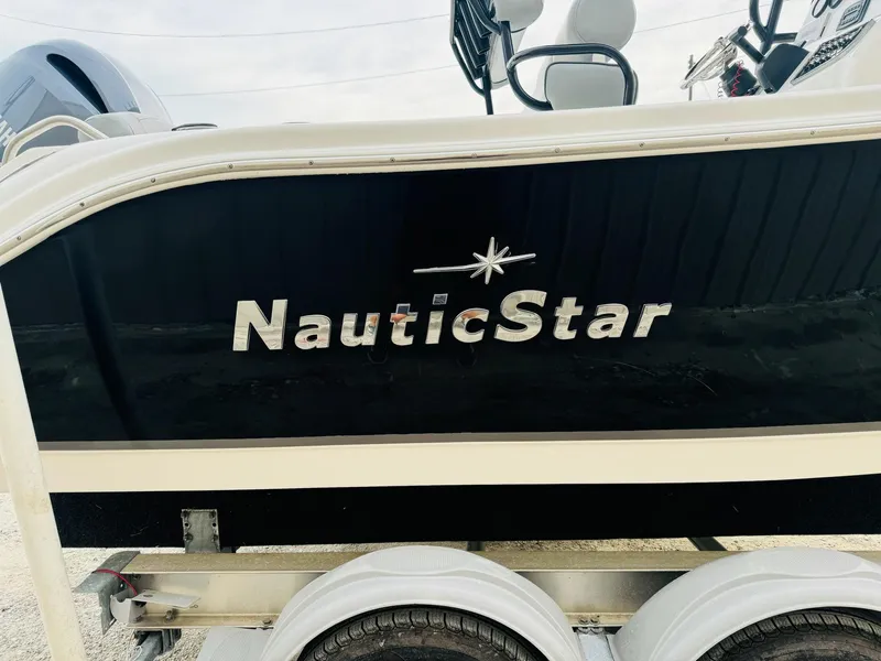 Slide: The Image of 2022 NauticStar 2102 Legacy boat side view with logo on trailer. - 16