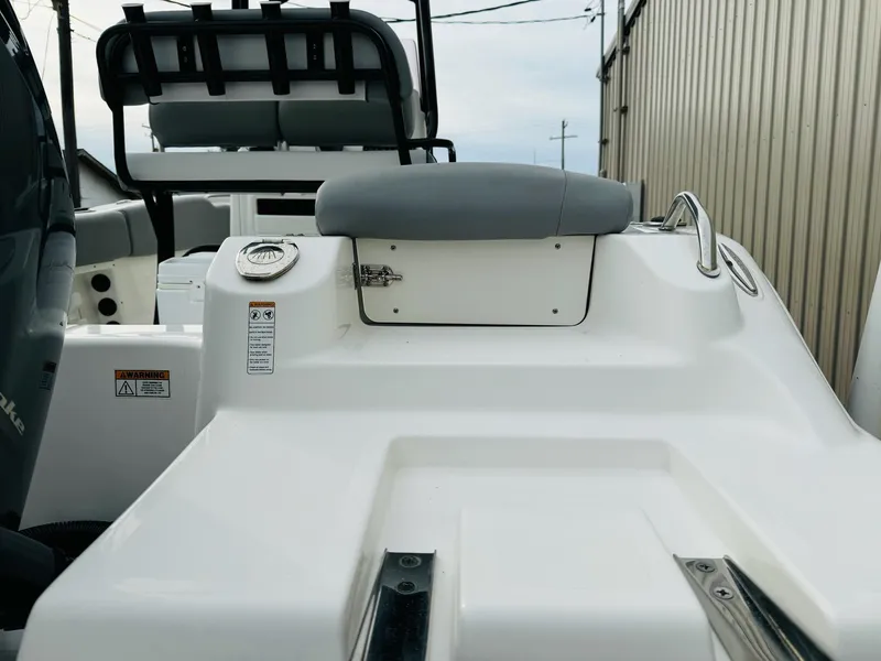 Slide: The Image of 2022 NauticStar 2102 Legacy boat interior with seating and storage features. - 17