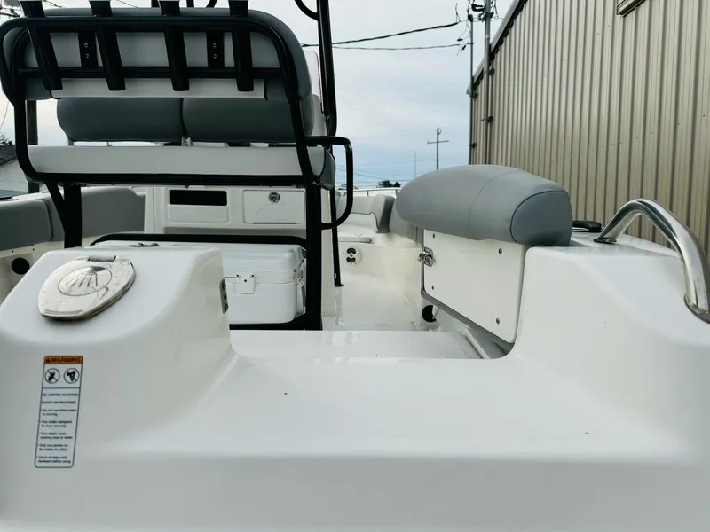Slide: The Image of 2022 NauticStar 2102 Legacy boat interior with seating and storage. - 18