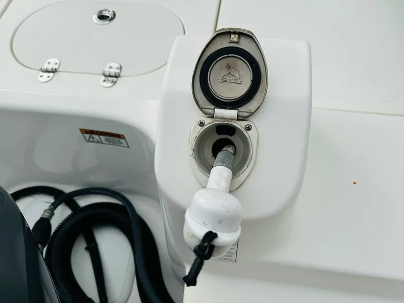 Slide: The Image of Fuel port of 2022 NauticStar 2102 Legacy boat, featuring a closed cap design. - 19