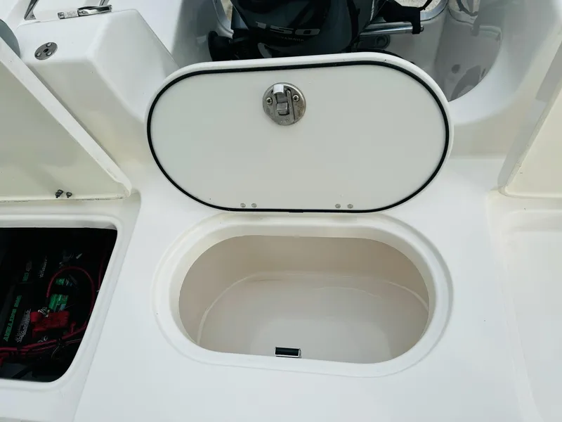 Slide: The Image of 2022 NauticStar 2102 Legacy boat storage compartments and hatch detail. - 22