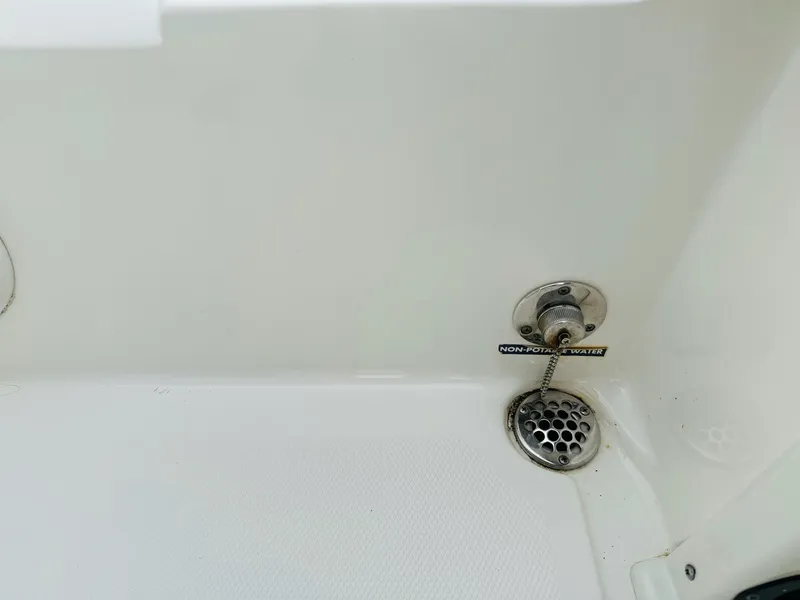 Slide: The Image of 2022 NauticStar 2102 Legacy boat drain and plug detail. - 24