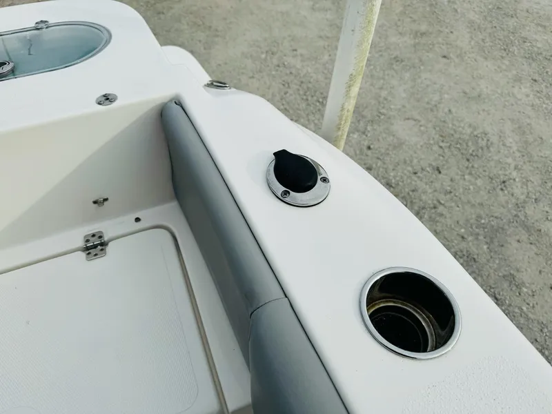 Slide: The Image of 2022 NauticStar 2102 Legacy boat interior with cup holders and seating. - 26
