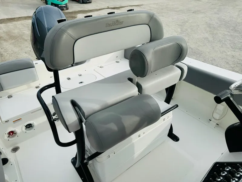 Slide: The Image of 2022 NauticStar 2102 Legacy boat seating with gray upholstery and black frame. - 31