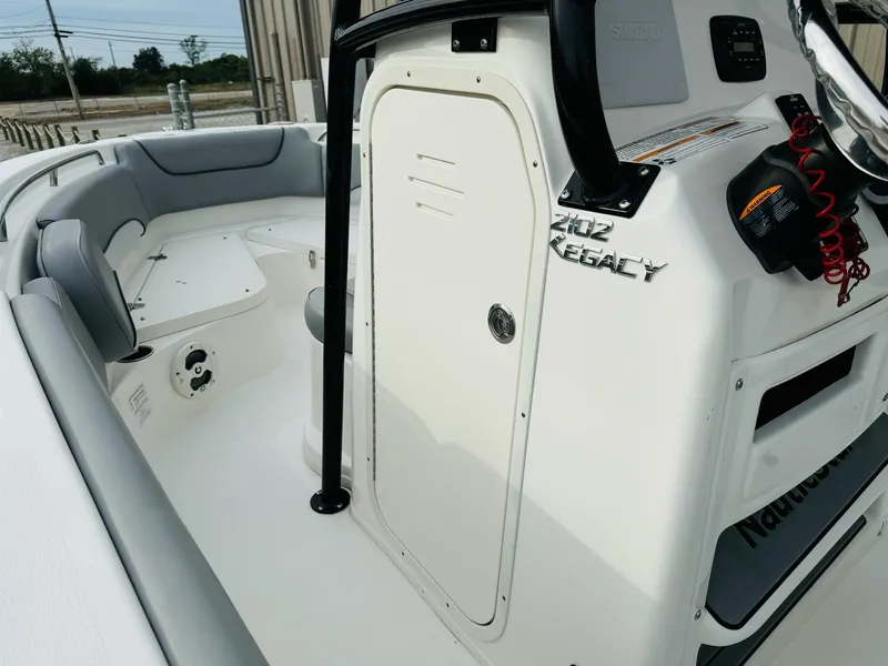 Slide: The Image of 2022 NauticStar 2102 Legacy boat interior with seating and console details. - 32