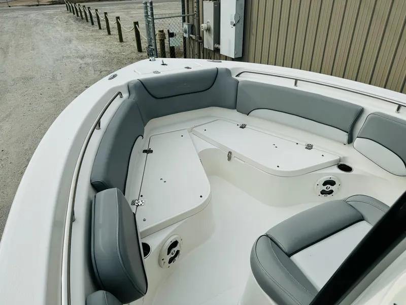 Slide: The Image of 2022 NauticStar 2102 Legacy boat interior with gray seating and storage compartments. - 33
