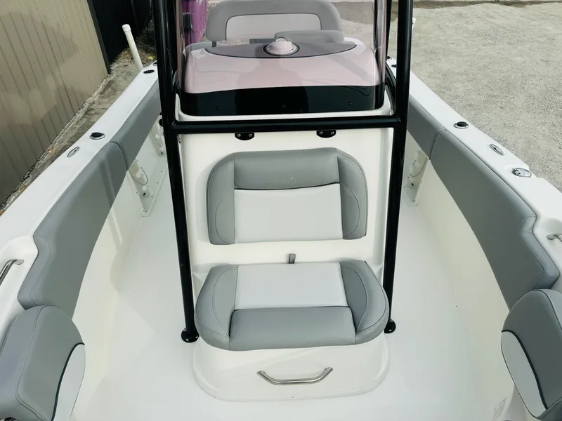 Slide: The Image of 2022 NauticStar 2102 Legacy boat interior with gray seating and console. - 34