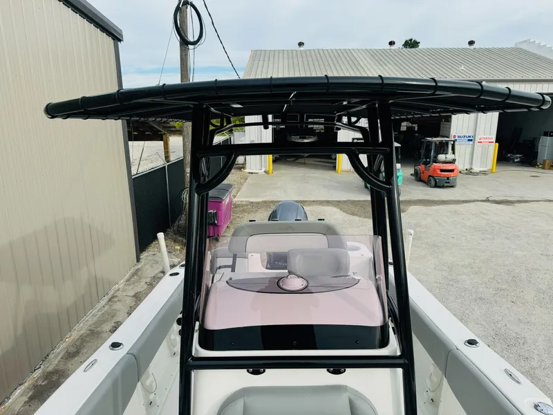 Slide: The Image of 2022 NauticStar 2102 Legacy boat with T-top in a marina setting. - 35