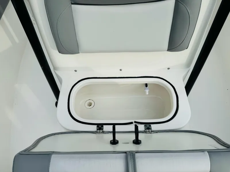 Slide: The Image of 2022 NauticStar 2102 Legacy boat interior with open storage compartment. - 36