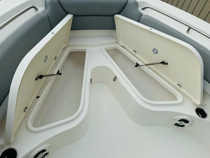 Slide: The Image of 2022 NauticStar 2102 Legacy boat with open storage compartments in the bow area. - 38