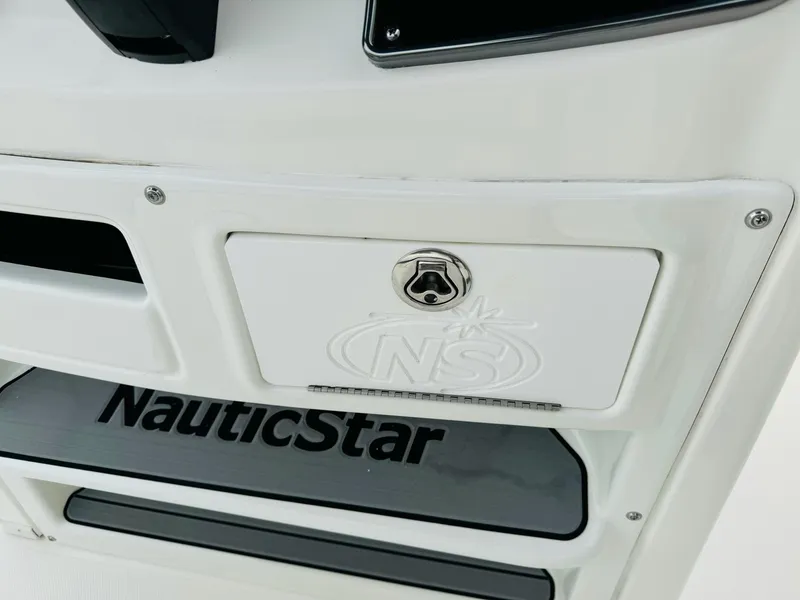 Slide: The Image of 2022 NauticStar 2102 Legacy boat detail with logo and storage compartment. - 42
