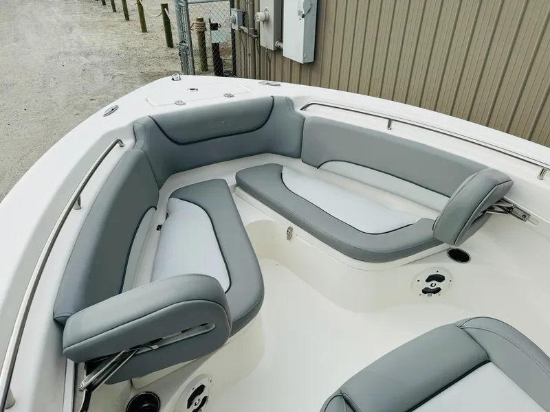 Slide: The Image of 2022 NauticStar 2102 Legacy boat with gray cushioned seating in the bow area. - 46