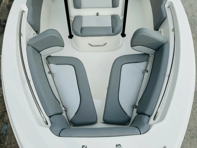 Slide: The Image of 2022 NauticStar 2102 Legacy boat interior with gray seating and white deck. - 47