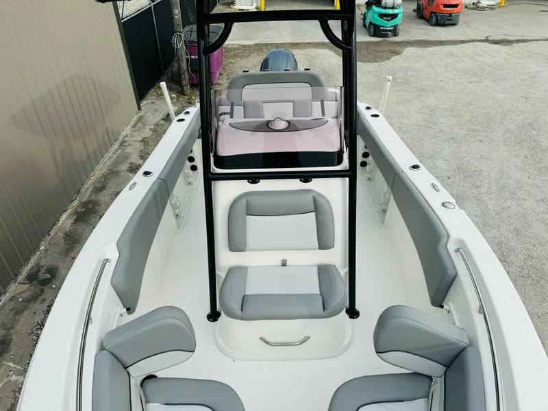 Slide: The Image of 2022 NauticStar 2102 Legacy boat interior with gray seating and center console. - 48