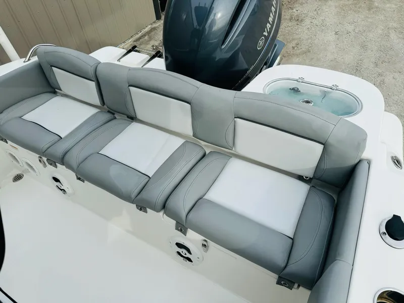 Slide: The Image of 2022 NauticStar 2102 Legacy boat with gray and white seating and Yamaha engine. - 49