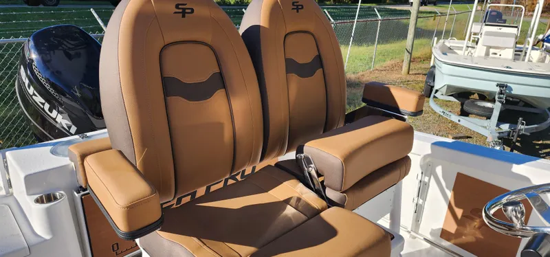 Slide: The Image of Seapro 222CC 2025 boat seats, brown leather, dual seating, outdoor setting. - 4