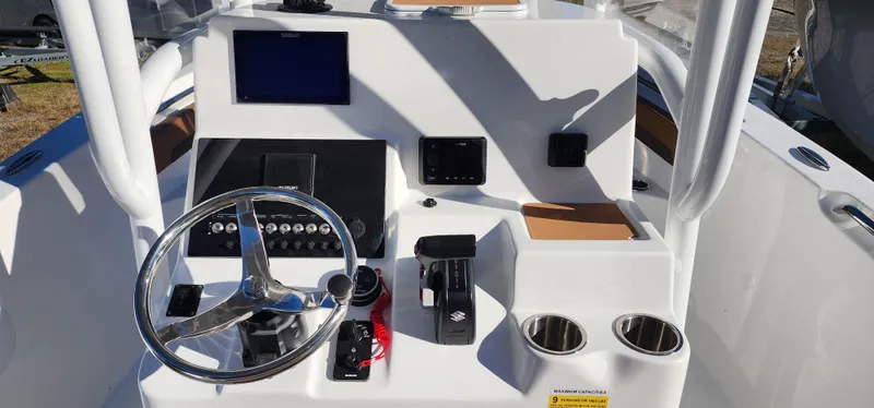 Slide: The Image of 2025 Seapro 222CC boat dashboard with steering wheel and controls. - 7