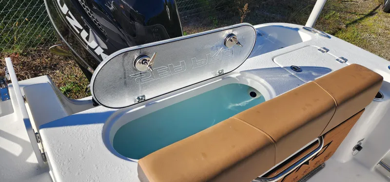 Slide: The Image of 2025 Seapro 222CC boat with open livewell and cushioned seating. - 9