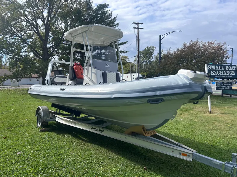 Slide: The Image of 2024 Highfield Sport 660 boat on trailer, displayed outdoors. - 10