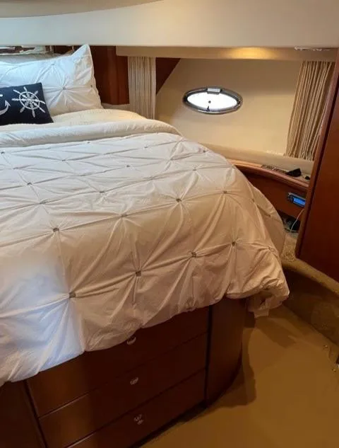 Slide: The Image of Interior of 2006 Silverton 43 Sport Bridge yacht with cozy bedroom and nautical decor. - 14