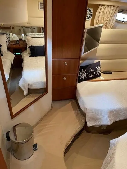 Slide: The Image of Interior of 2006 Silverton 43 Sport Bridge yacht with cozy bedroom and nautical decor. - 16