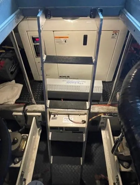 Slide: The Image of Engine room of 2006 Silverton 43 Sport Bridge with Kohler generator and ladder access. - 32