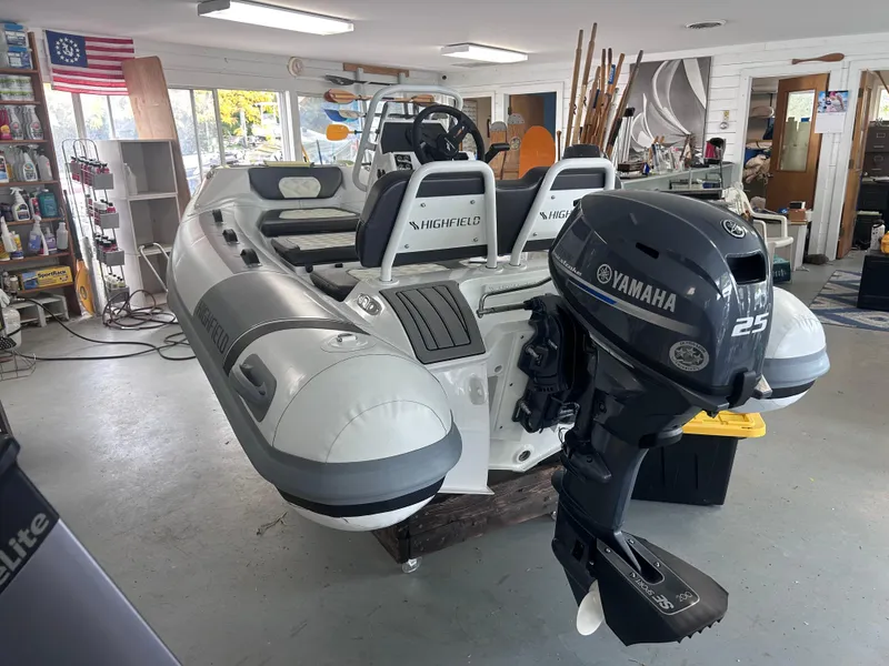 Slide: The Image of 2022 Highfield Sport 300 boat with Yamaha 25 outboard motor in a showroom. - 5