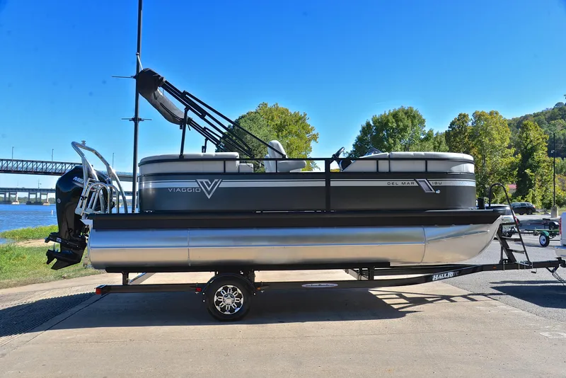 Slide: The Image of 2023 Viaggio DM18U pontoon boat on trailer by riverside, clear blue sky. - 14