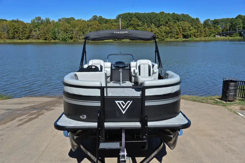 Slide: The Image of 2023 Viaggio DM18U pontoon boat at a lakeside dock. - 16